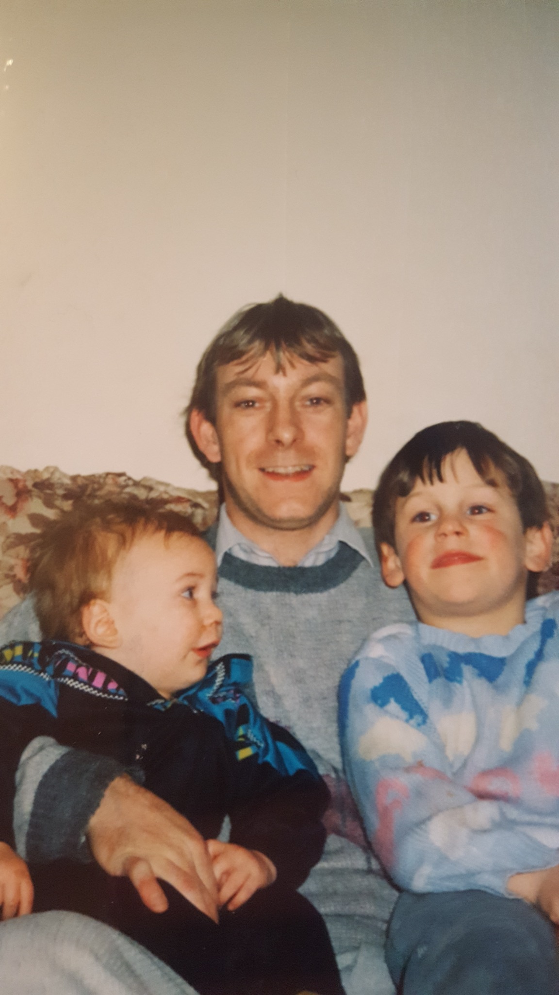 A family photo of me, my dad, and my brother.